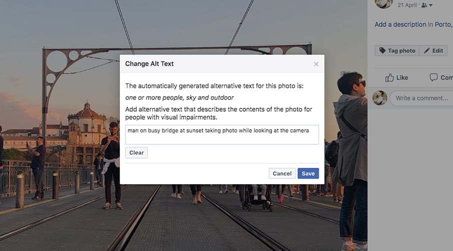 Description box with unique alt text that says 'man on busy bridge at sunset taking a photo while looking at the camera.